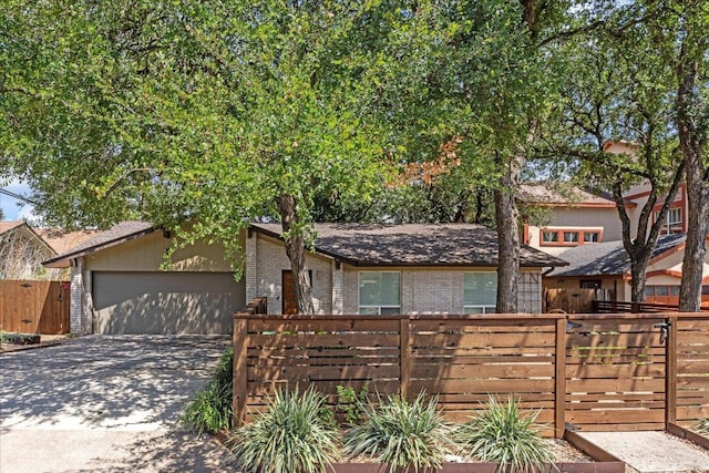 8101 Ceberry Dr, Austin, TX 78759 - view of front of house featuring brick siding, concrete driveway, and a garage