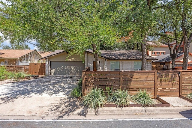 8101 Ceberry Dr, Austin, TX 78759 - mid-century inspired home featuring brick siding, concrete driveway, and a garage