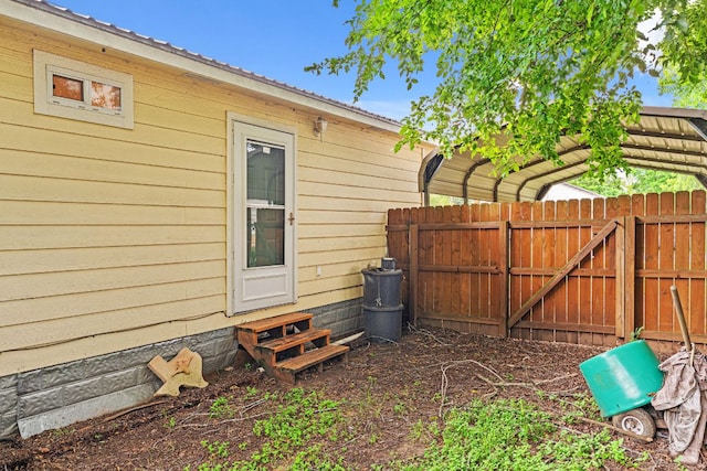 300 Walker St, Smithville, TX 78957 - view of yard with entry steps, a detached carport, and a gate