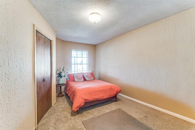 10745 Rosemar Ln, Adkins, TX 78101 - carpeted bedroom featuring a textured ceiling and a closet