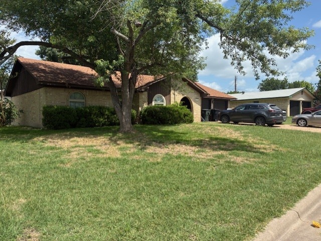 410 Phoenix Dr, Temple, TX 76504 - view of front of house featuring a front lawn, a garage, and brick siding