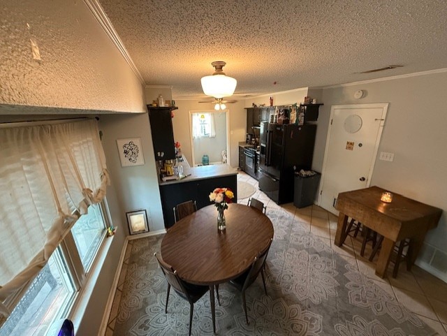 410 Phoenix Dr, Temple, TX 76504 - dining area with ornamental molding, a textured ceiling, light tile patterned floors, and ceiling fan