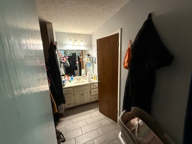 410 Phoenix Dr, Temple, TX 76504 - bathroom with a textured ceiling and vanity