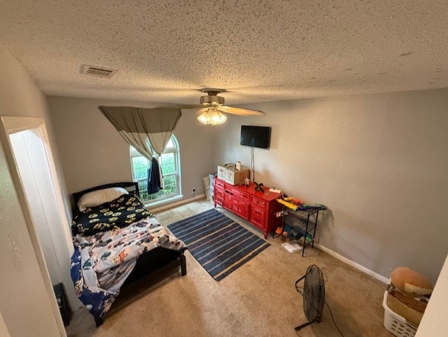 410 Phoenix Dr, Temple, TX 76504 - carpeted bedroom featuring a textured ceiling and ceiling fan