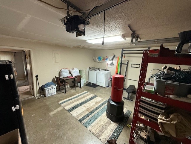 410 Phoenix Dr, Temple, TX 76504 - garage featuring washer and dryer, a garage door opener, and freestanding refrigerator