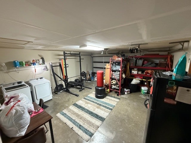 410 Phoenix Dr, Temple, TX 76504 - garage with independent washer and dryer, freestanding refrigerator, and a garage door opener