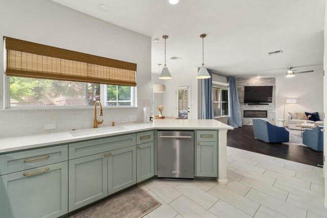 5701 Sunset Rdg, Austin, TX 78735 - kitchen featuring stainless steel dishwasher, green cabinets, open floor plan, backsplash, and recessed lighting