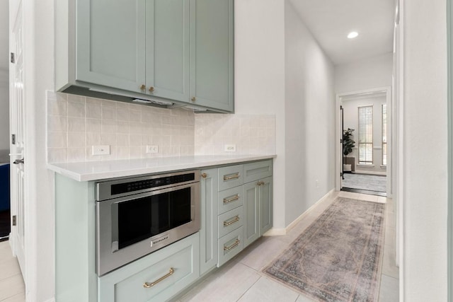 5701 Sunset Rdg, Austin, TX 78735 - kitchen with light countertops, light tile patterned floors, decorative backsplash, stainless steel oven, and recessed lighting
