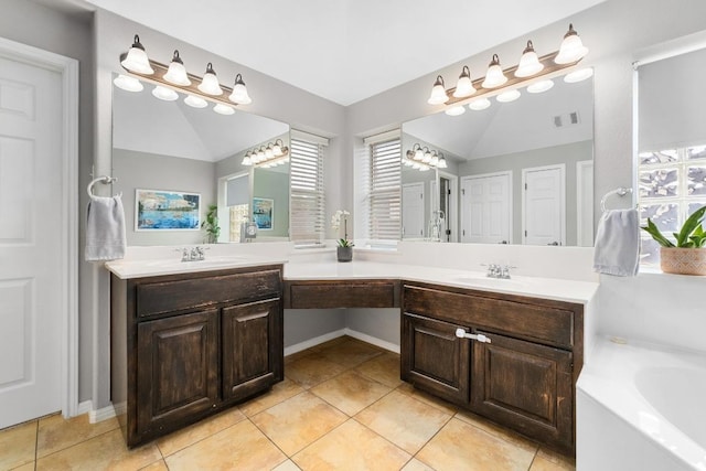5701 Sunset Rdg, Austin, TX 78735 - full bathroom featuring lofted ceiling, double vanity, tile patterned flooring, a chandelier, and a bath