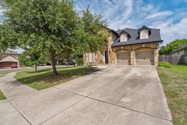 5701 Sunset Rdg, Austin, TX 78735 - traditional-style home with stone siding, driveway, an attached garage, and roof with shingles