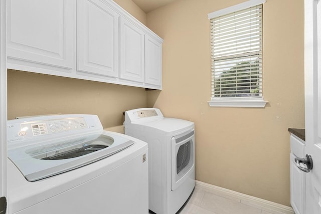 5701 Sunset Rdg, Austin, TX 78735 - laundry area featuring cabinet space, washer and clothes dryer, and light tile patterned floors