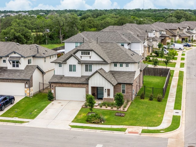 453 Arrowhead Vine St, Leander, TX 78641 - view of front of home with board and batten siding, an attached garage, driveway, roof with shingles, and a residential view