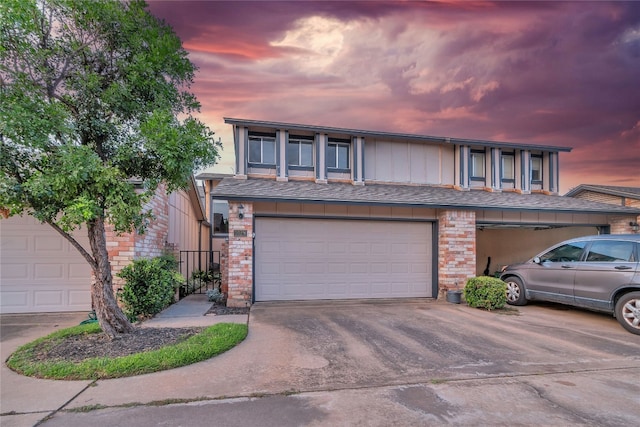 1028 Verbena Dr Unit 1144, Austin, TX 78750 - townhome / multi-family property featuring driveway, brick siding, and a garage