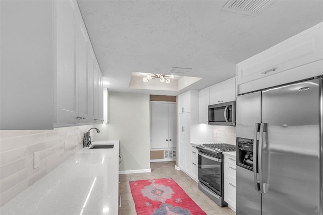 1028 Verbena Dr Unit 1144, Austin, TX 78750 - kitchen with stainless steel appliances, tasteful backsplash, light tile patterned floors, and light countertops