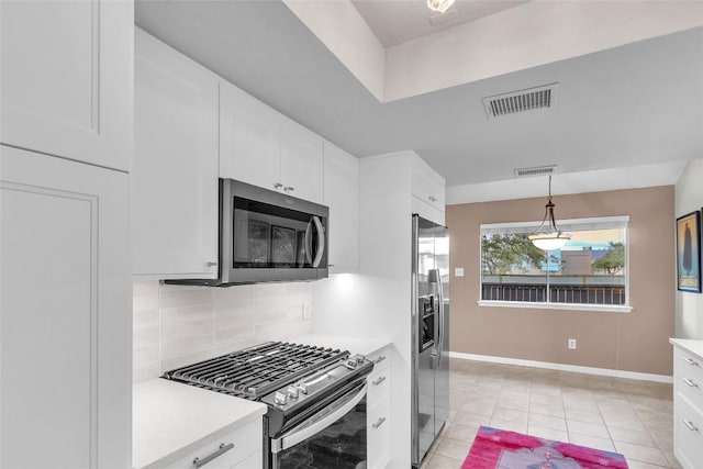 1028 Verbena Dr Unit 1144, Austin, TX 78750 - kitchen with stainless steel appliances, light countertops, backsplash, white cabinets, and hanging light fixtures