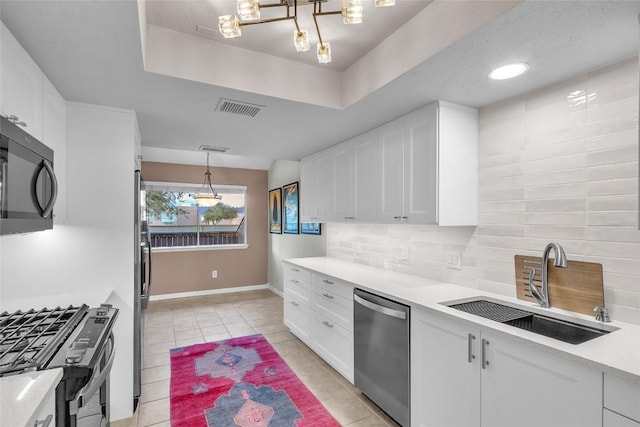 1028 Verbena Dr Unit 1144, Austin, TX 78750 - kitchen featuring stainless steel appliances, light tile patterned floors, and white cabinets