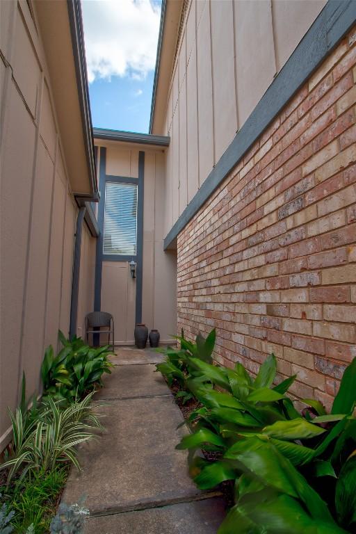 1028 Verbena Dr, Austin, TX 78750 - entrance to property featuring board and batten siding and brick siding