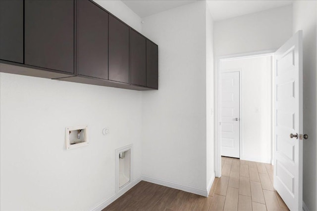 8213 Spire Vw, Austin, TX 78744 - washroom featuring cabinet space, washer hookup, and wood finished floors