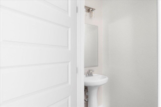 8213 Spire Vw, Austin, TX 78744 - bathroom featuring a textured wall and a sink