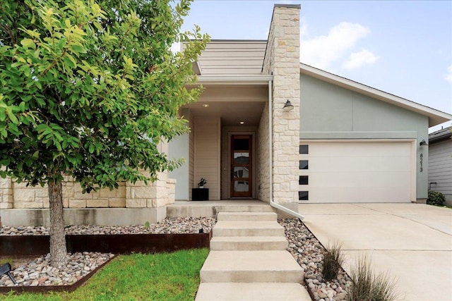 8213 Spire Vw, Austin, TX 78744 - view of front of house featuring driveway, an attached garage, and a chimney