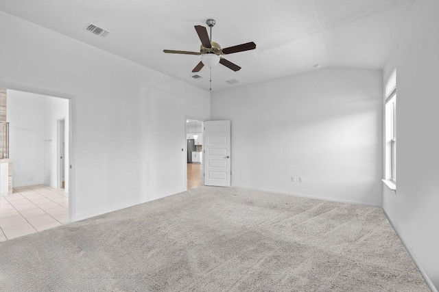 8213 Spire Vw, Austin, TX 78744 - empty room featuring ceiling fan, light colored carpet, and vaulted ceiling