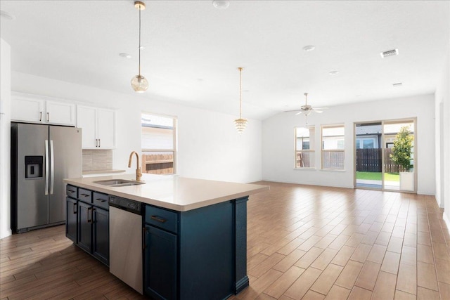 8213 Spire Vw, Austin, TX 78744 - kitchen with stainless steel appliances, healthy amount of natural light, wood finished floors, and open floor plan