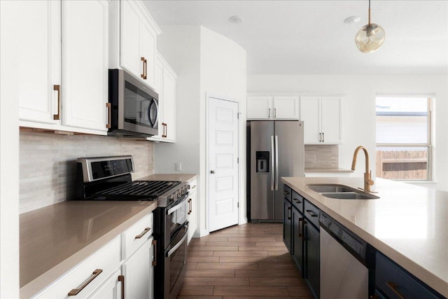 8213 Spire Vw, Austin, TX 78744 - kitchen featuring appliances with stainless steel finishes, white cabinetry, dark wood-style flooring, light countertops, and tasteful backsplash