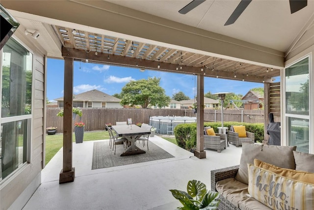 239 Holman Path, Hutto, TX 78634 - fenced backyard with an outdoor hangout area, a patio, outdoor dining area, a ceiling fan, and a residential view