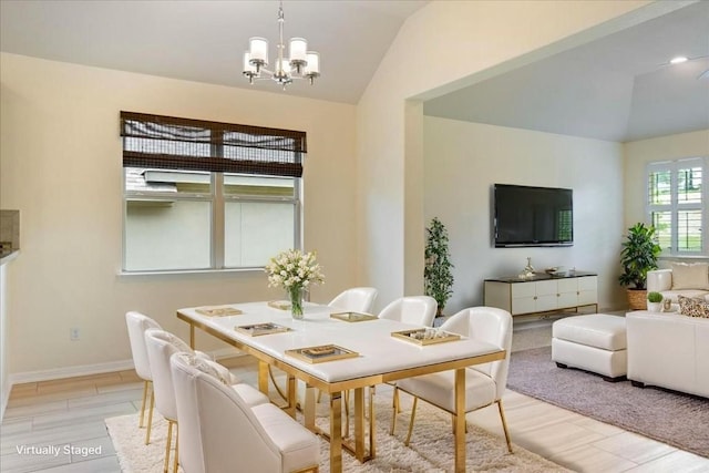 2520 Milan Meadows Dr, Leander, TX 78641 - dining area with lofted ceiling, a chandelier, and light wood-style floors