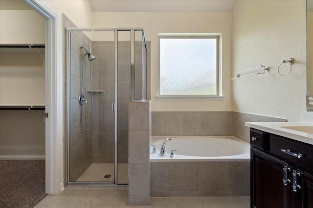 2520 Milan Meadows Dr, Leander, TX 78641 - bathroom featuring vanity, a bath, a stall shower, and a spacious closet
