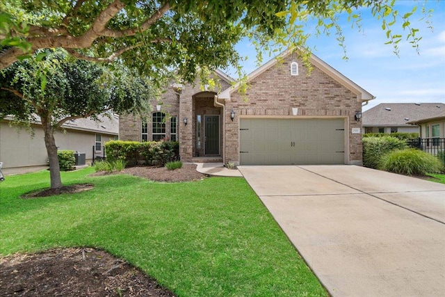 2520 Milan Meadows Dr, Leander, TX 78641 - traditional-style house with a garage, driveway, a front lawn, and brick siding