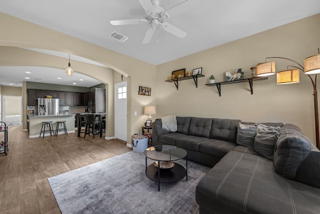 1420 Anhalt Dr Unit 50B, Pflugerville, TX 78660 - living room featuring arched walkways, light wood-style flooring, a ceiling fan, and recessed lighting