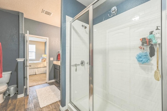 1420 Anhalt Dr Unit 50B, Pflugerville, TX 78660 - bathroom with wood finished floors, a textured wall, a shower stall, ensuite bathroom, and a textured ceiling