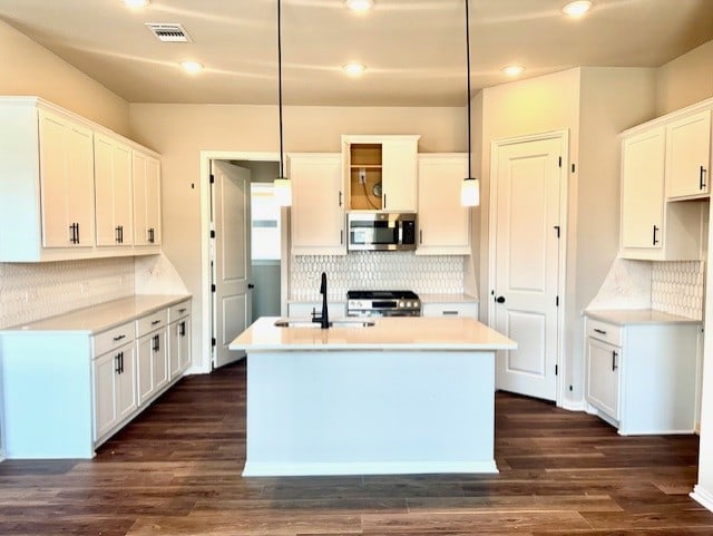 370 Milkwood Ter, Dripping Springs, TX 78620 - kitchen with stainless steel appliances, tasteful backsplash, a center island with sink, and recessed lighting