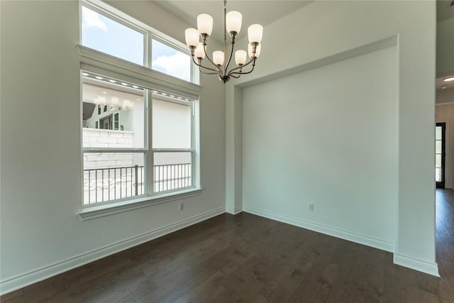 152 Limestone Dr, Georgetown, TX 78628 - spare room featuring plenty of natural light, a chandelier, and dark wood finished floors