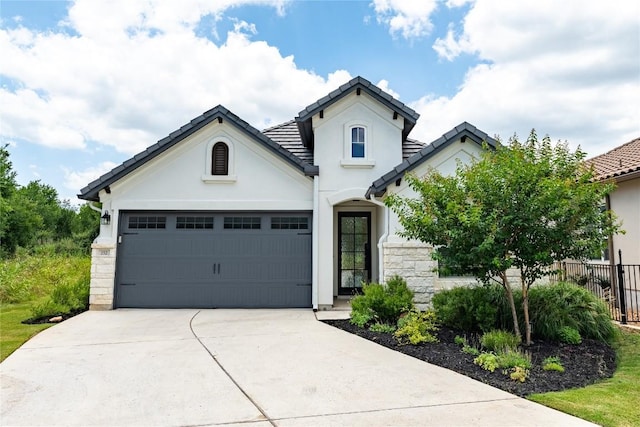 152 Limestone Dr, Georgetown, TX 78628 - view of front of property featuring driveway, stucco siding, a garage, a tile roof, and stone siding