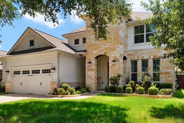 103 County Road 180 Unit 35, Leander, TX 78641 - view of front of house featuring a front lawn, stone siding, an attached garage, stucco siding, and a shingled roof