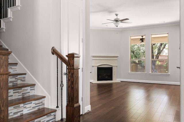 103 County Road 180 Unit 35, Leander, TX 78641 - unfurnished living room featuring ceiling fan, crown molding, stairway, wood finished floors, and a glass covered fireplace