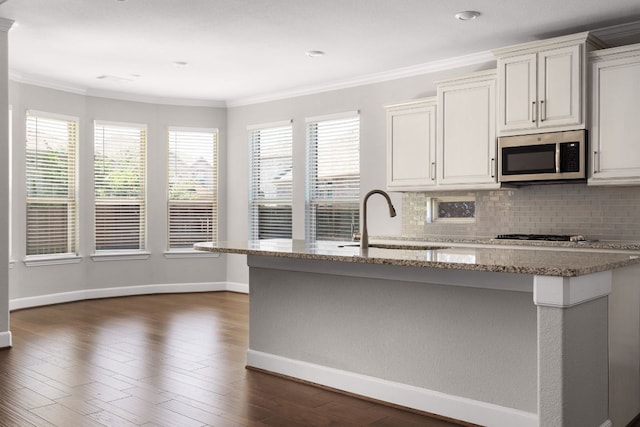 103 County Road 180 Unit 35, Leander, TX 78641 - kitchen featuring appliances with stainless steel finishes, crown molding, tasteful backsplash, light stone counters, and dark wood-style flooring