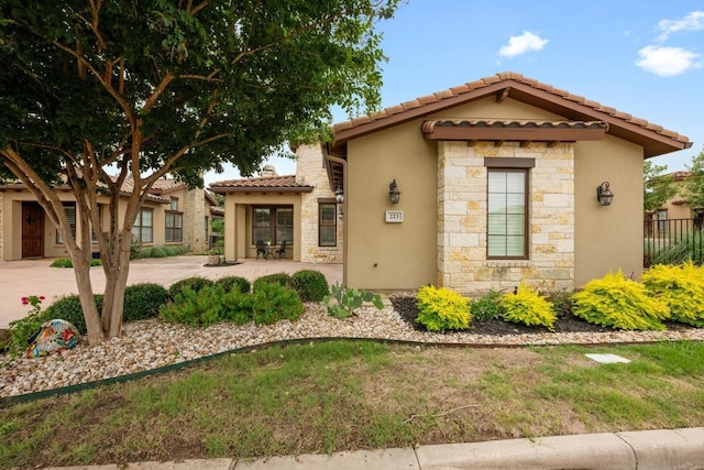 223 Delfino Cir, Austin, TX 78734 - mediterranean / spanish home with stucco siding, a tile roof, and stone siding