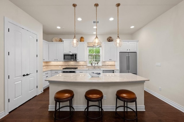 223 Delfino Cir, Austin, TX 78734 - kitchen featuring stainless steel appliances, a center island, backsplash, white cabinetry, and recessed lighting