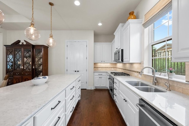 223 Delfino Cir, Austin, TX 78734 - kitchen with stainless steel appliances, dark wood finished floors, white cabinets, and recessed lighting