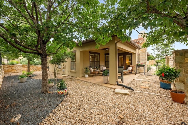 223 Delfino Cir, Austin, TX 78734 - back of property with stucco siding, a patio, a fenced backyard, and an outdoor hangout area