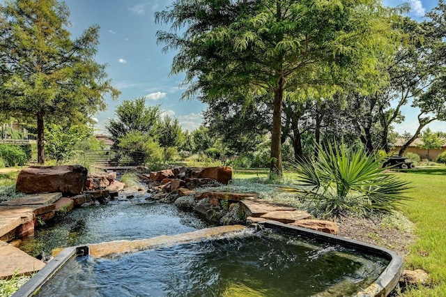 223 Delfino Cir, Austin, TX 78734 - view of pool featuring a garden pond and an outdoor hot tub