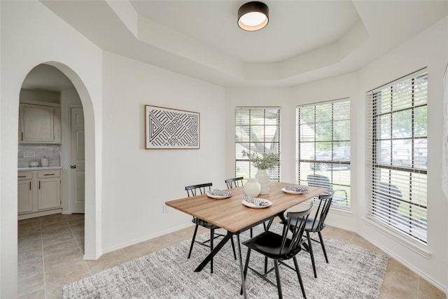 16302 Bates Cv, Pflugerville, TX 78660 - dining area with a raised ceiling, light tile patterned floors, and arched walkways