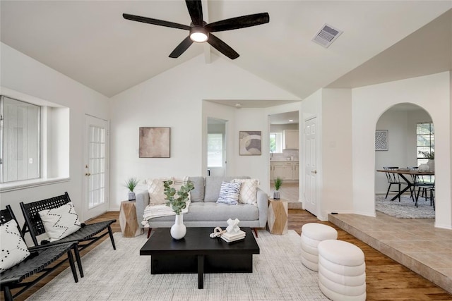 16302 Bates Cv, Pflugerville, TX 78660 - living area with arched walkways, ceiling fan, lofted ceiling, and wood finished floors