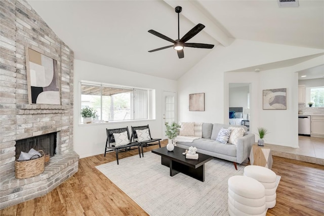16302 Bates Cv, Pflugerville, TX 78660 - living room with ceiling fan, light wood-style flooring, and a brick fireplace