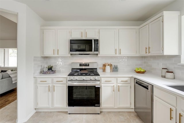 16302 Bates Cv, Pflugerville, TX 78660 - kitchen with stainless steel appliances, white cabinetry, light countertops, and tasteful backsplash