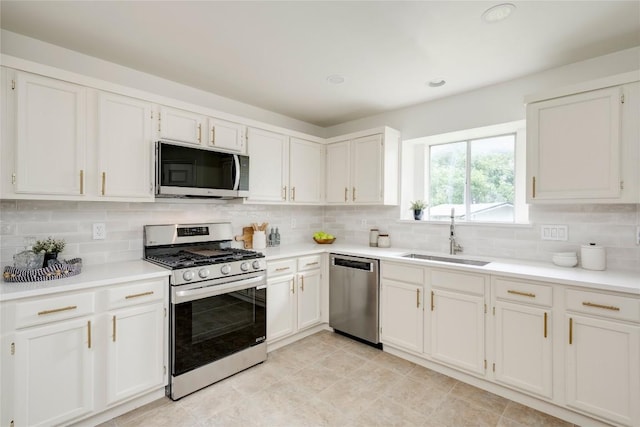 16302 Bates Cv, Pflugerville, TX 78660 - kitchen featuring appliances with stainless steel finishes, decorative backsplash, light countertops, white cabinets, and recessed lighting