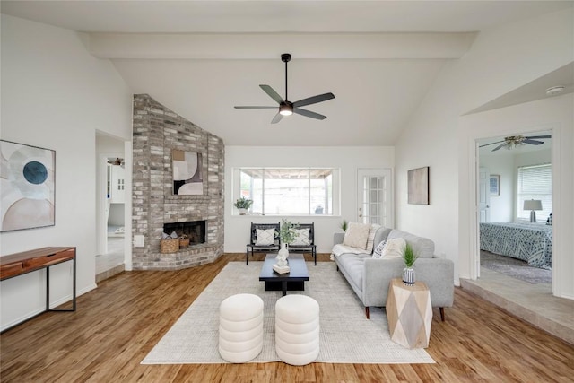 16302 Bates Cv, Pflugerville, TX 78660 - living room featuring ceiling fan, wood finished floors, a fireplace, high vaulted ceiling, and beam ceiling